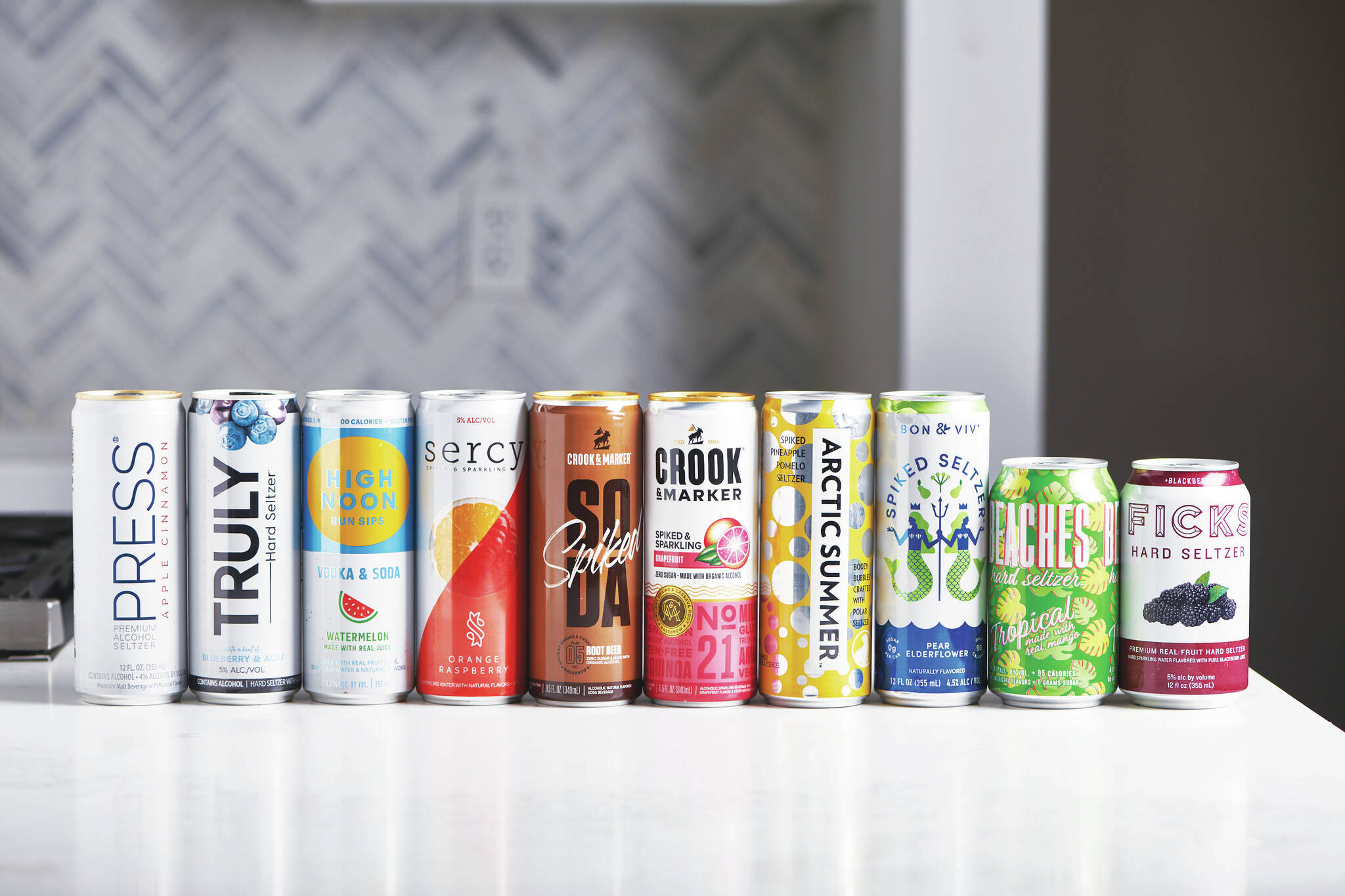 This January 2020 photo shows a selection of hard seltzer on a counter in New York. The most recent "it drink" is hard seltzer, served on plenty of patios and sidewalk tables during this pandemic summer. Hard seltzer, also known as spiked seltzer or hard sparkling water, contains carbonated water, alcohol and flavoring. (Cheyenne Cohen/Katie Workman via AP)