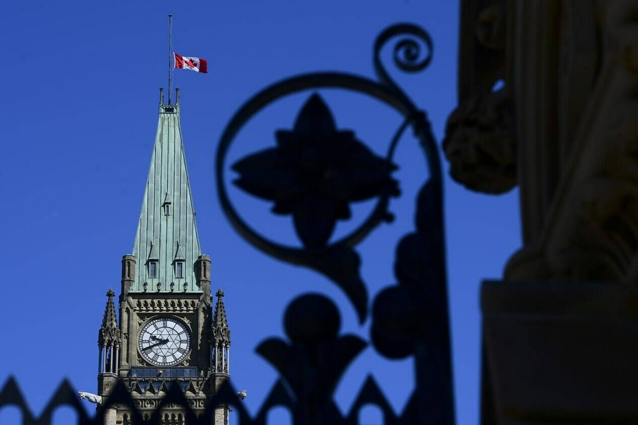 The Canadian flag on the Peace Tower flies at half-mast on Parliament Hill in Ottawa on Wednesday, June 2, 2021, in recognition of the discovery of children’s remains at the site of a former residential school in Kamloops, B.C. The Canadian government, Assembly of First Nations and plaintiffs in two class-action lawsuits have signed a $20-billion final settlement agreement to compensate First Nations children and families harmed by chronic underfunding of child welfare and the government’s narrow definition of Jordan’s Principle. THE CANADIAN PRESS/Sean Kilpatrick