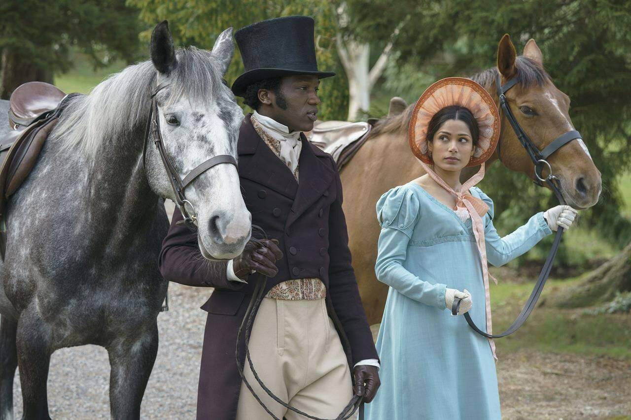 This image released by Bleecker Street shows Ṣọpẹ́ Dìrísù, left, and Freida Pinto in a scene from “Mr. Malcolm’s List.” (Ross Ferguson/Bleecker Street via AP)