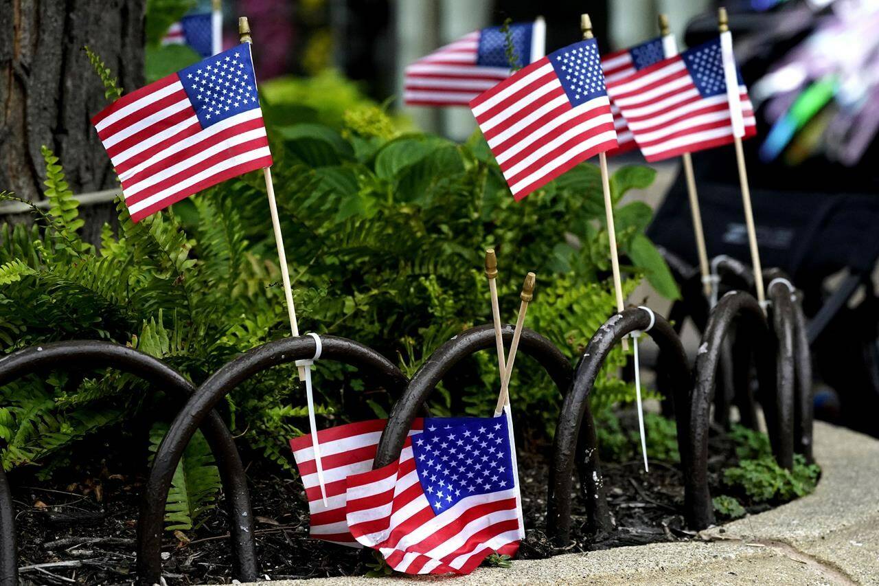 American flags are pictured after a mass shooting at the Highland Park Fourth of July parade in downtown Highland Park, Ill., a Chicago suburb on Monday, July 4, 2022. (AP Photo/Nam Y. Huh)