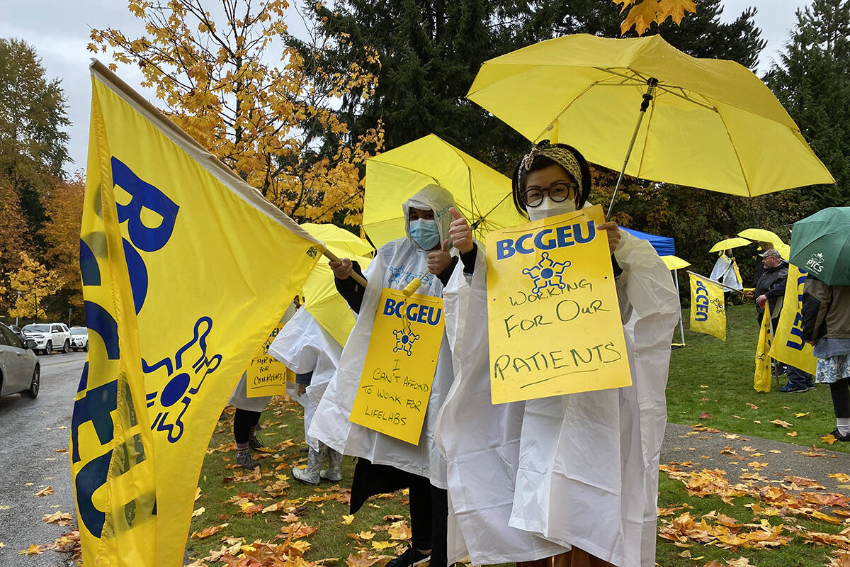 LifeLabs workers represented by BCEGU strike outside LifeLabs administrative offices in Burnaby on Oct. 23. (Cole Schisler photo)