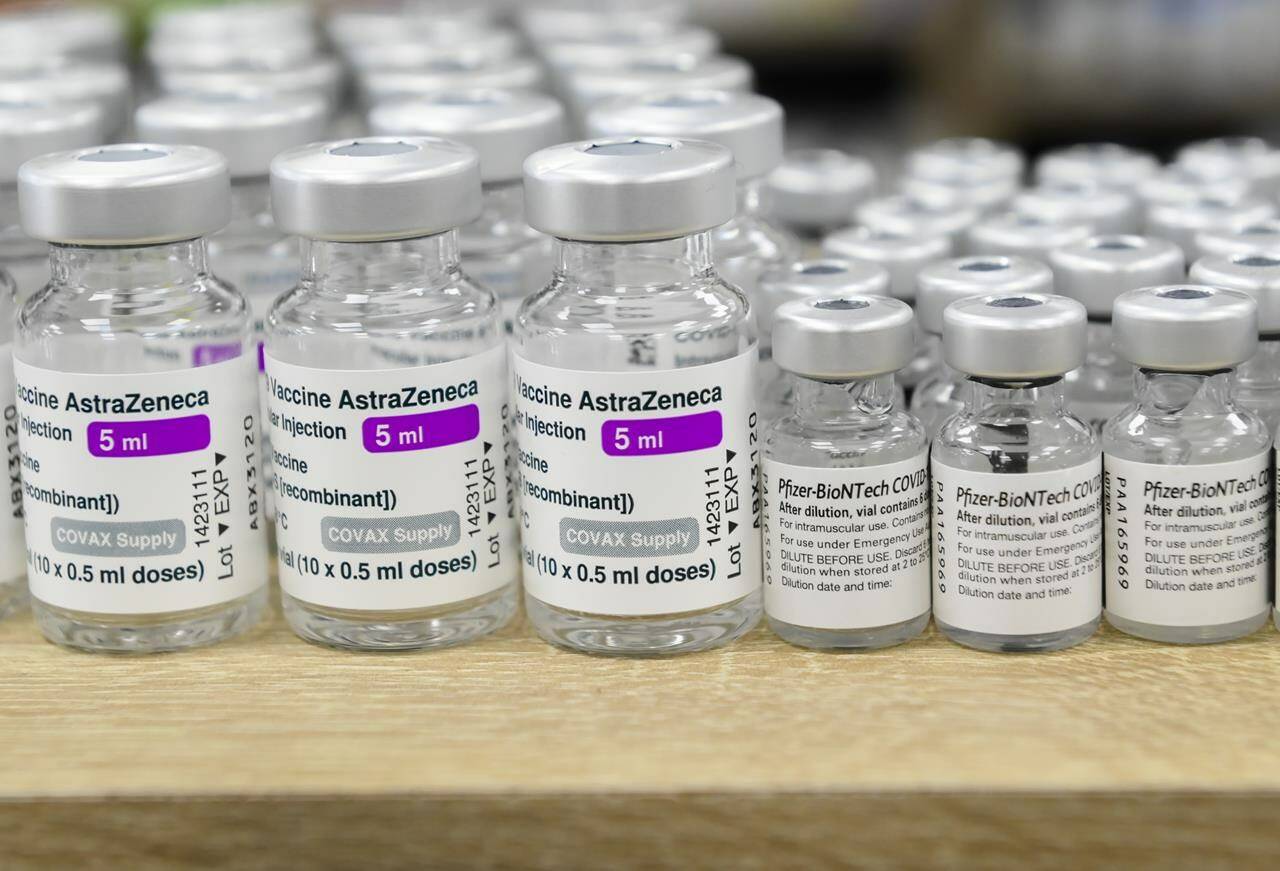Vials of both Pfizer-BioNTech and Oxford-AstraZeneca COVID-19 vaccines sit empty on the counter at the Junction Chemist Pharmacy, in Toronto on June 18, 2021. THE CANADIAN PRESS/Nathan Denette