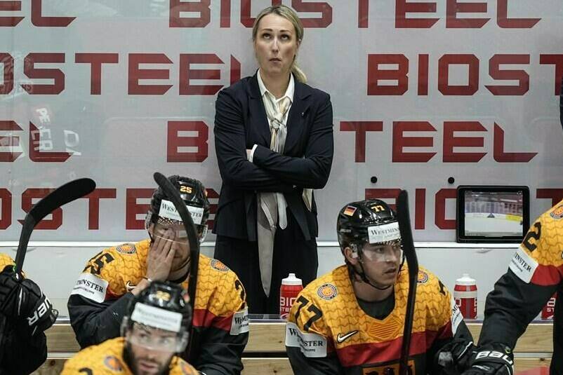 Germany assistant coach Jessica Campbell stands behind players at the German bench during the group A Hockey World Championship match between France and Germany in Helsinki, Finland, Monday May 16, 2022. The Coachella Valley Firebirds have hired Campbell, the American Hockey League’s first female assistant coach. THE CANADIAN PRESS/AP-Martin Meissner