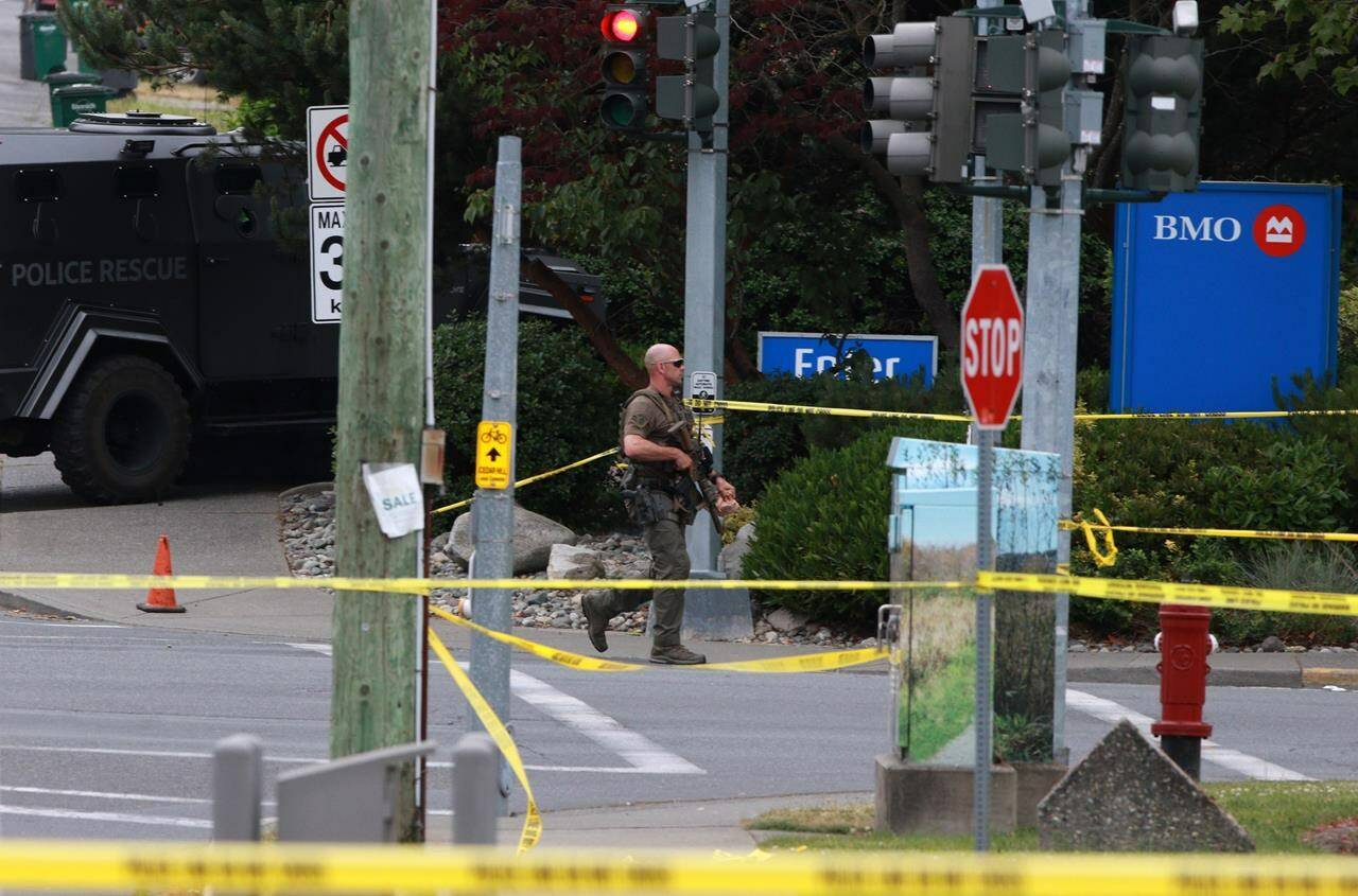 Saanich Police joined by Victoria Police and RCMP respond to shots of gunfire involving multiple people and injuries reported at the Bank of Montreal during an active situation in Saanich, B.C., on Tuesday, June 28, 2022 THE CANADIAN PRESS/Chad Hipolito