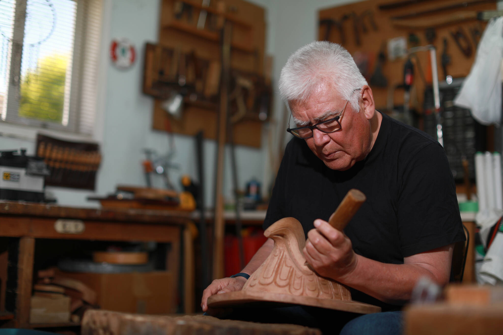 First Nations artist Richard Hunt began carving at the age of 13 now at 71 he continues to hone his skills as he works on his latest piece the Sun Mask using red cedar to create his one of a kind artwork at his studio in Victoria, B.C., on Thursday, June 30, 2022 THE CANADIAN PRESS/Chad Hipolito