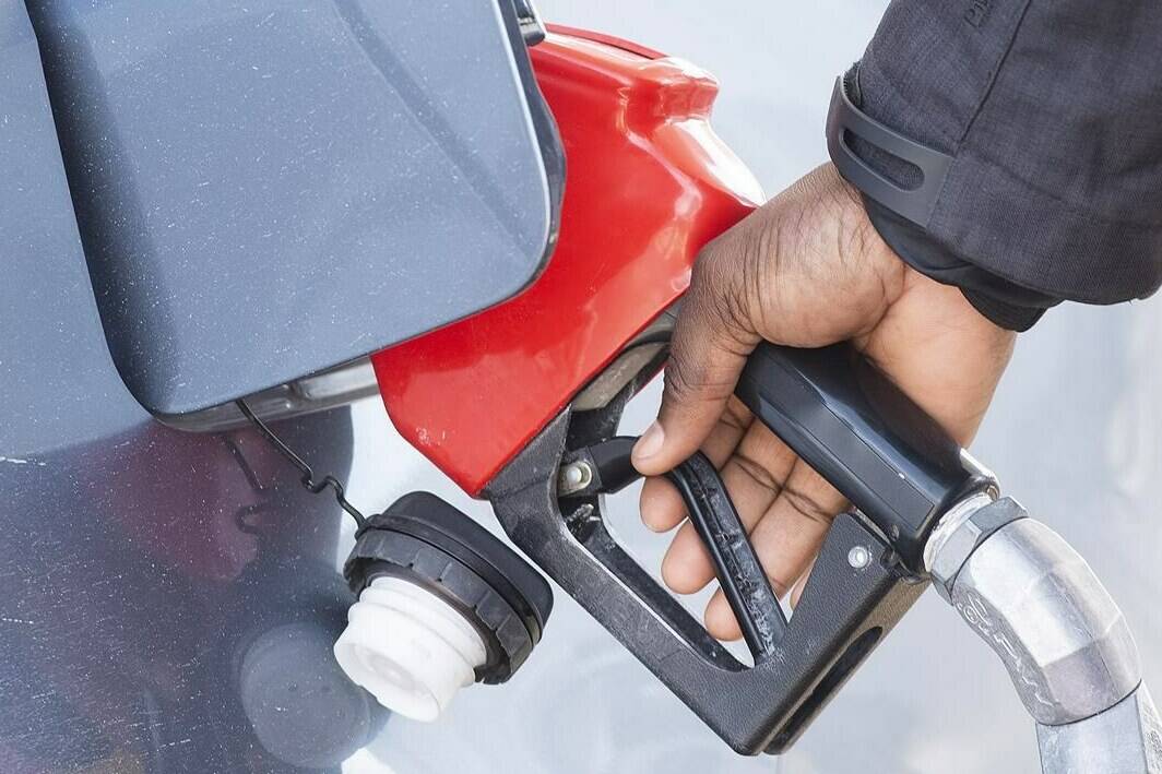 A man pumps gas in Montreal, Friday, March 4, 2022. Gasoline prices have dropped about 12 cents a litre overnight in Ontario and are down across much of Canada after a big dip in the price of oil this week. THE CANADIAN PRESS/Graham Hughes
