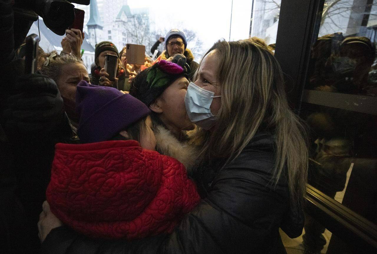 Tamara Lich, an organizer “Freedom Convoy” embraces supporters as she leaves the courthouse in Ottawa after being granted bail, on Monday, March 7, 2022. THE CANADIAN PRESS/Justin Tang