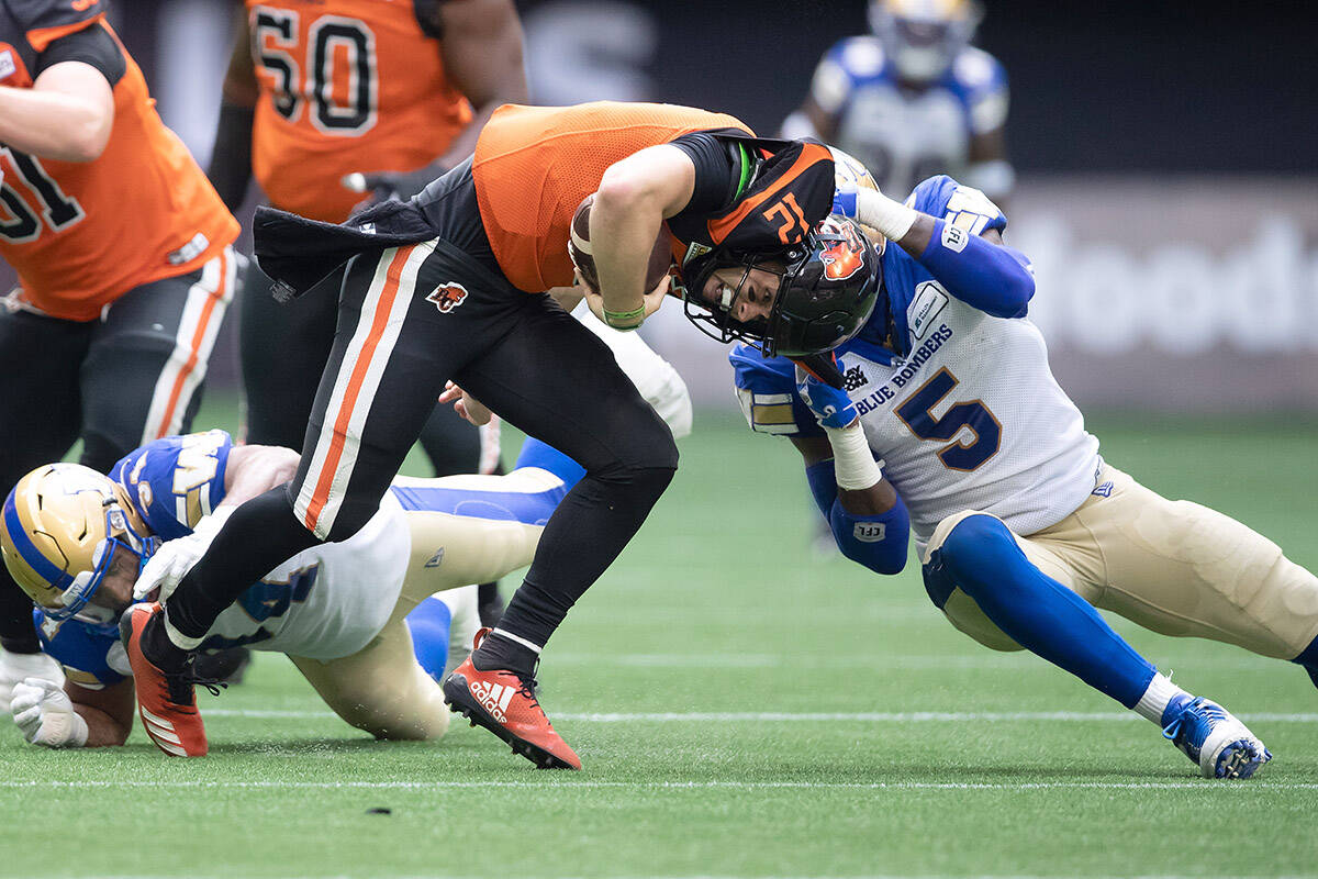B.C. Lions quarterback Nathan Rourke (12) is sacked by Winnipeg Blue Bombers’ Willie Jefferson (5) during the first half of CFL football game in Vancouver, on Saturday, July 9, 2022. THE CANADIAN PRESS/Darryl Dyck