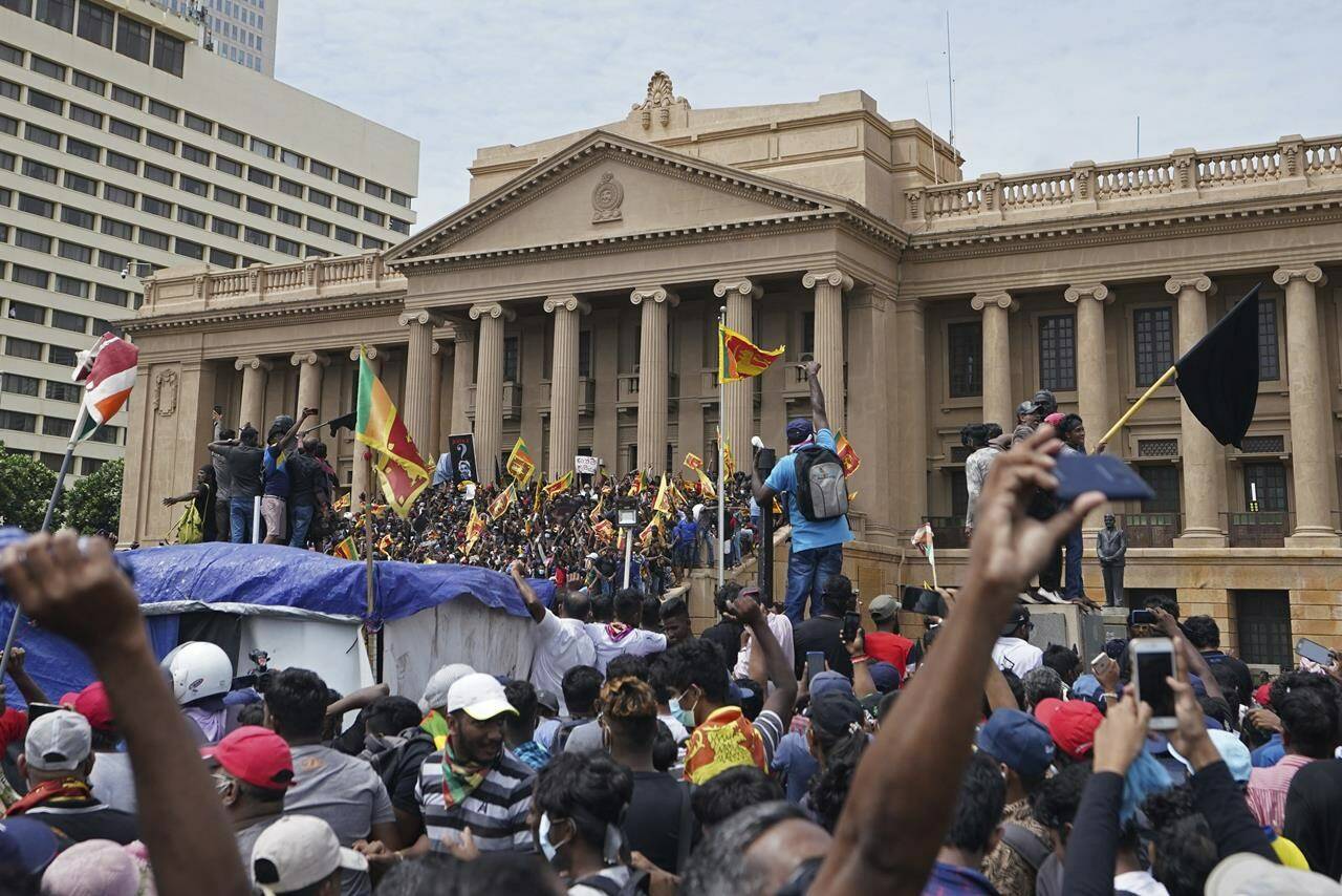 Protesters, many carrying Sri Lankan flags, gather outside the presidents office in Colombo, Sri Lanka, Saturday, July 9, 2022. Sri Lankan protesters stormed President Gotabaya Rajapaksa’s residence and nearby office on Saturday as tens of thousands of people took to the streets of the capital Colombo in the biggest demonstration yet to vent their fury against a leader they hold responsible for the island nation’s worst economic crisis. (AP Photo/Thilina Kaluthotage)