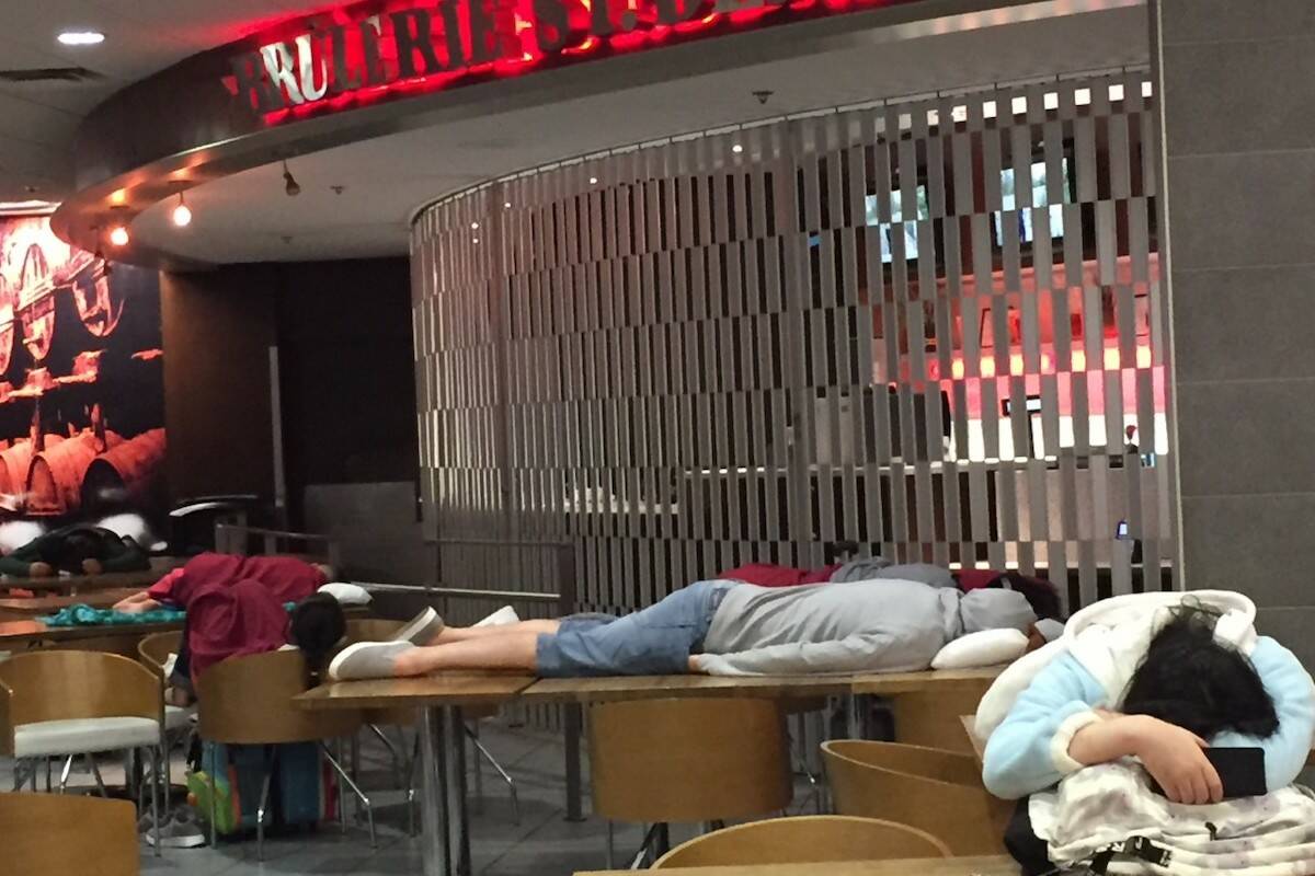 Exhausted travellers having a nap in the airport. (Carla Leinweber/Submitted)
