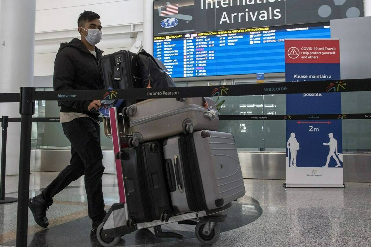Mandatory random COVID-19 testing resumes today for travellers coming in through Canada's four major airports in Toronto, Vancouver, Calgary and Montreal. A passenger from Air India flight 187 from New Delhi arrives at Pearson Airport in Toronto on Wednesday April 21, 2021. THE CANADIAN PRESS/Frank Gunn