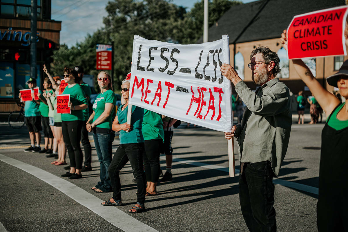A local climate advocacy group stood with 80 protesters at the intersection of Bernard Avenue and Richter Street in protest of the annual RibFest Kelowna in August 2019. (Black Press Media files)