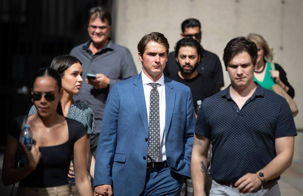 Former Vancouver Canucks NHL hockey player Jake Virtanen, centre, leaves B.C. Supreme Court after testifying at his sexual assault trial, in Vancouver, on Thursday, July 21, 2022. THE CANADIAN PRESS/Darryl Dyck