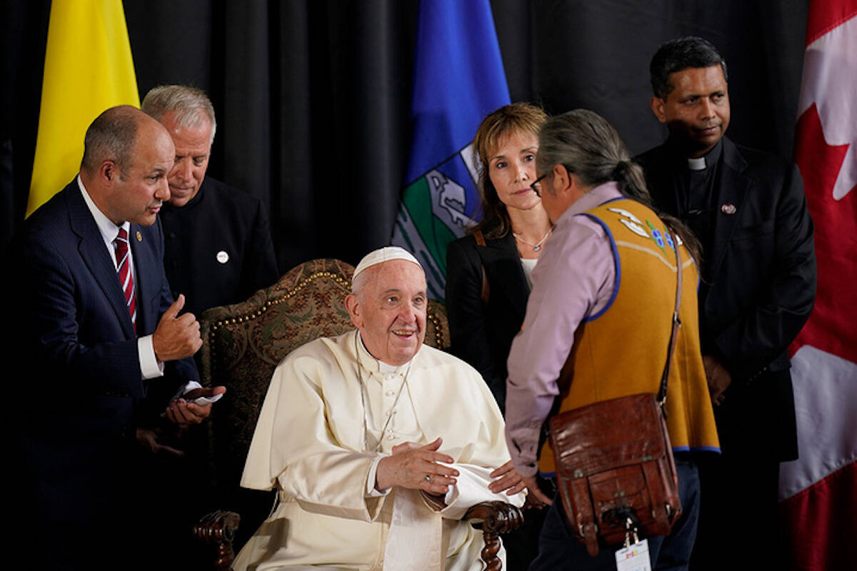Pope Francis is welcomed by a group of Indigenous leaders Sunday, July 24, 2022, in Edmonton, Alberta, Canada. (AP Photo/Eric Gay)