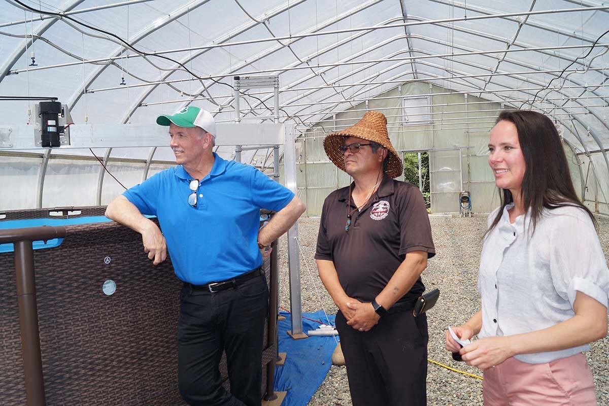 B.C. Premier John Horgan and T’Sou-ke Nation Chief Gordie Planes listen to an explanation from Synergraze founder and CEO Tamara Loiselle on how the spore tank works at a demonstration project in a greenhouse that’s home to an innovative project aimed at reducing methane gas emissions from livestock. (Rick Stiebel - Sooke News Mirror)