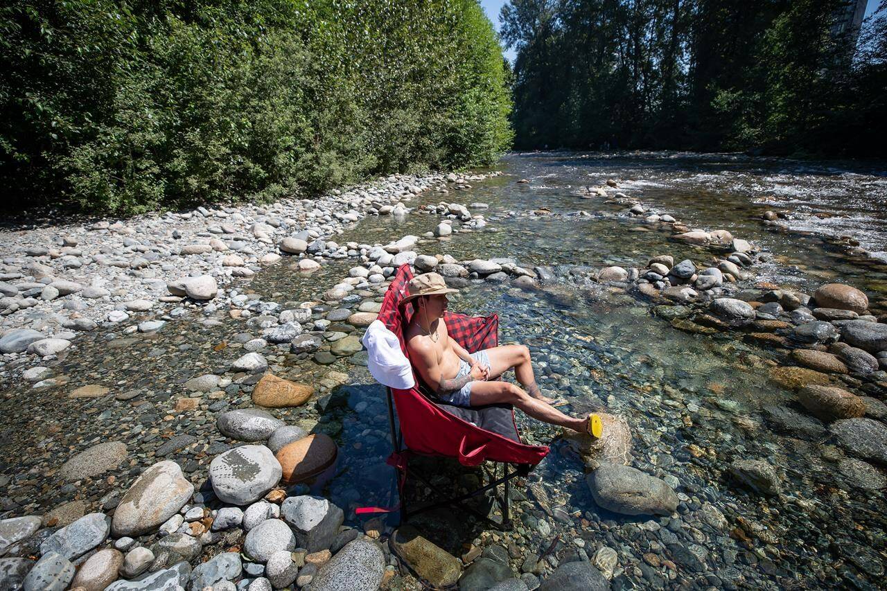 Albert Huynh cools off in Lynn Creek in North Vancouver, B.C., on June 28, 2021. Heat warnings have been posted across a much of British Columbia as Environment Canada predicts temperatures up to 40 C. THE CANADIAN PRESS/Darryl Dyck