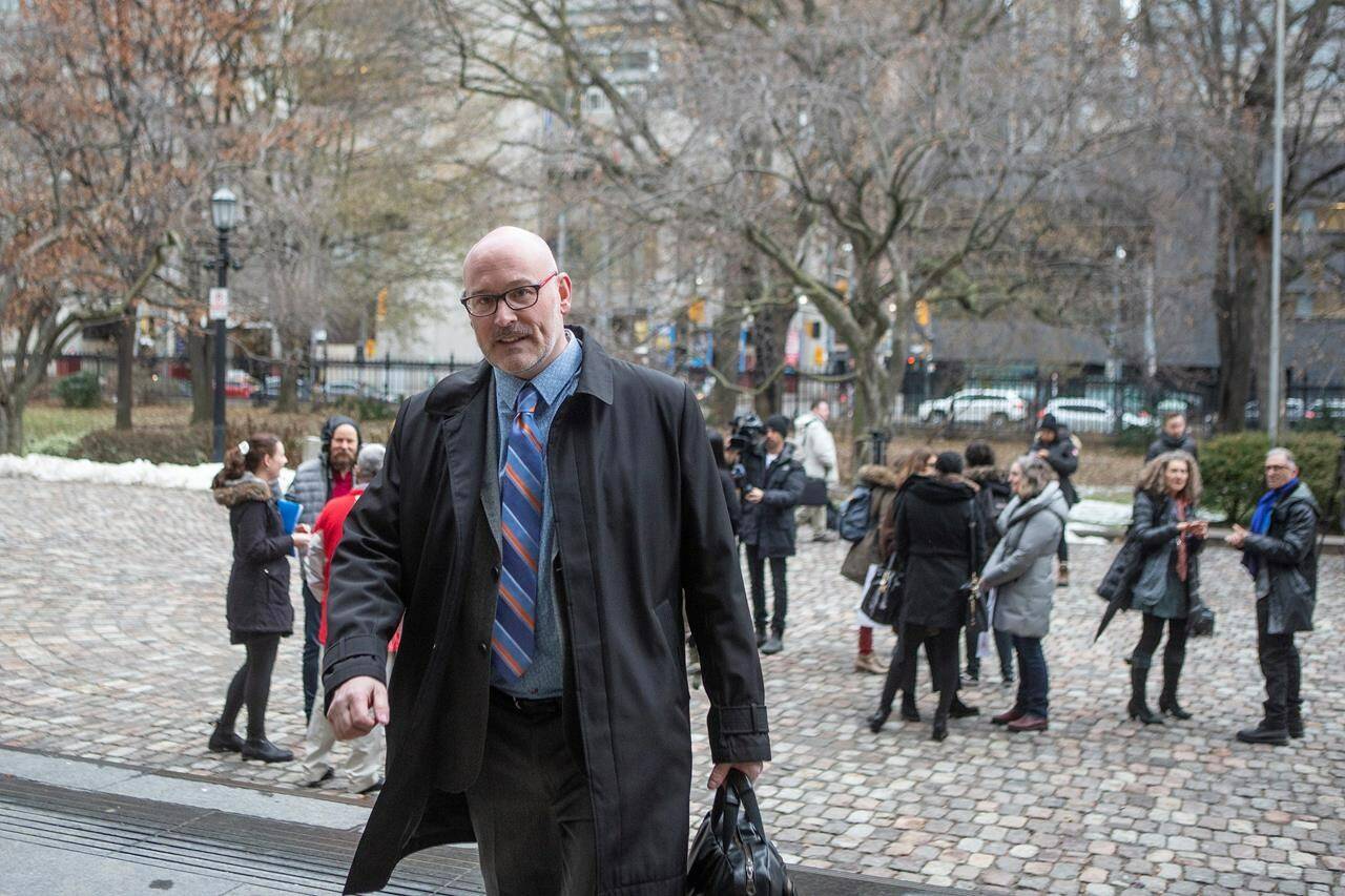 Richard Elliott makes his way into a Toronto court, on Monday, Nov. 9, 2019. Canadian HIV and AIDS organizations say the start of an international AIDS conference in Montreal this week is shining a light on Canada’s lagging response to the disease. Elliott, a former executive director of the HIV Legal Network, a Toronto-based advocacy organization, says that not only has funding been frozen but money is increasingly being used to fight other sexually transmitted diseases. THE CANADIAN PRESS/Chris Young