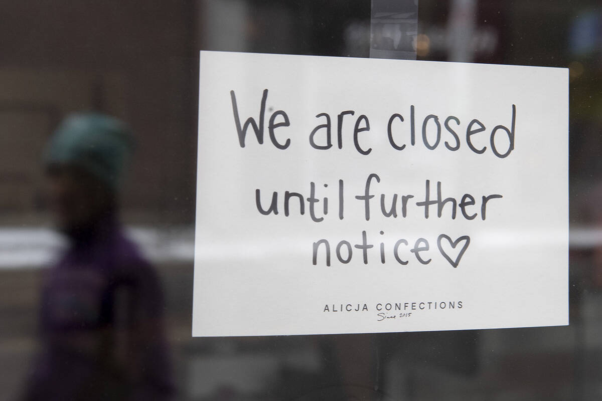 A sign on a shop window indicates the store is closed in Ottawa, Monday March 23, 2020. THE CANADIAN PRESS/Adrian Wyld