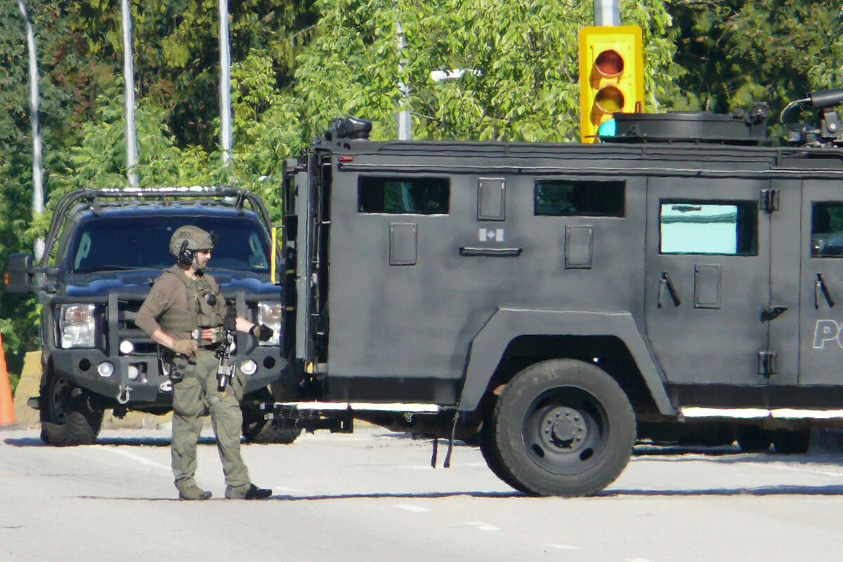 Emergency Response Team officers (ERT) and armoured trucks were on scene in Langley where police were negotiating with a man inside a townhouse on 72nd Avenue on Tuesday afternoon. (Dan Ferguson/Langley Advance Times)