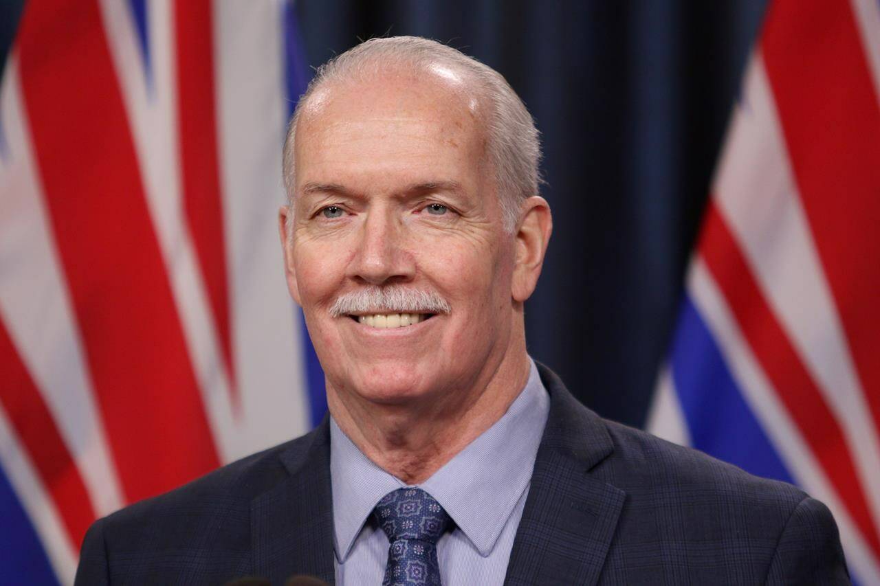 Premier John Horgan answers questions from the media in Victoria, B.C., on Tuesday, February 8, 2022. The premier says he’s considering taking the same approach as a Victoria couple who placed a newspaper ad to find a family doctor in his attempt to pressure the federal government to increase health funding.THE CANADIAN PRESS/Chad Hipolito