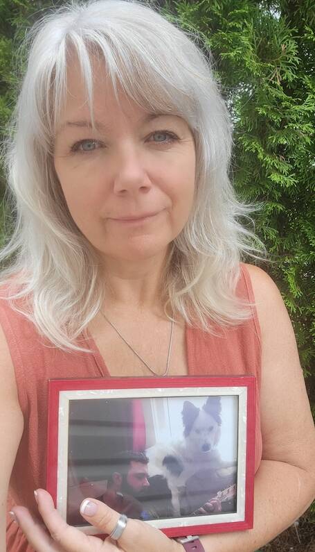 Judi Hills holds a picture of her son, Sam.