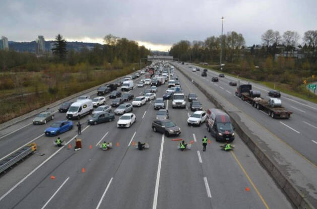 Activists with Save Old Growth block traffic on the Trans-Canada Highway in Metro Vancouver in May 2022, calling for an end to old-growth logging in British Columbia. (THE CANADIAN PRESS/HO-Save Old Growth)