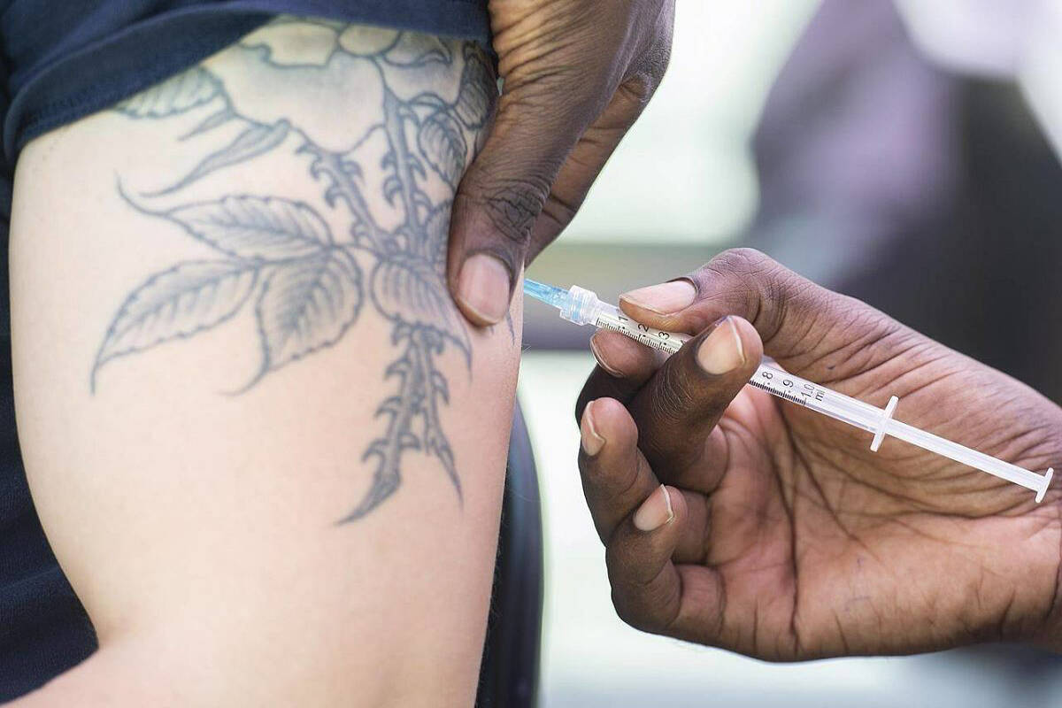 A man receives a monkeypox vaccine at an outdoor walk-in clinic in Montreal, Saturday, July 23, 2022. The British Columbia government says monkeypox vaccine is being made available to eligible patients in most areas of the province. THE CANADIAN PRESS/Graham Hughes