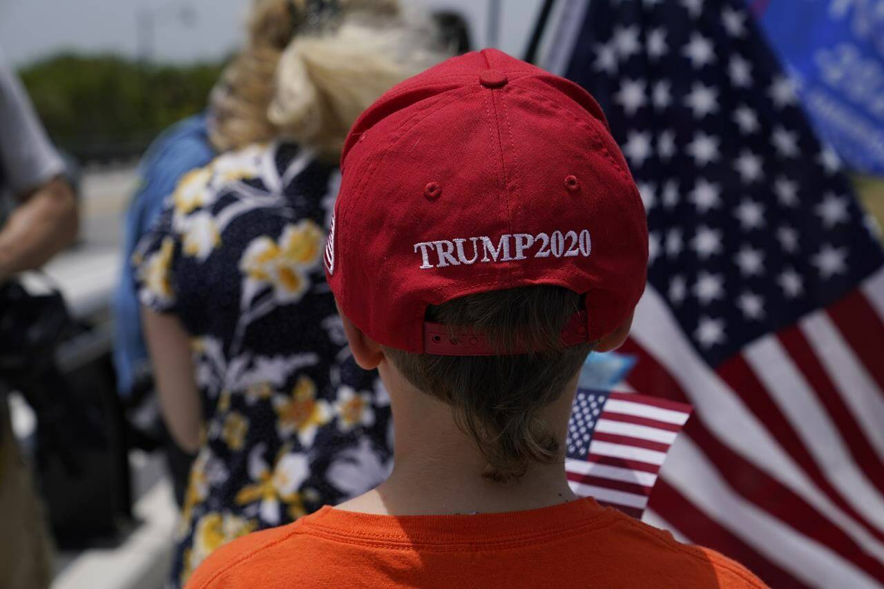 Edward Barkovskaya walks along a bridge near an entrance to former President Donald Trump’s Mar-a-Lago estate, Tuesday, Aug. 9, 2022, in Palm Beach, Fla. The FBI searched Trump’s Mar-a-Lago estate as part of an investigation into whether he took classified records from the White House to his Florida residence, people familiar with the matter said Monday. (AP Photo/Lynne Sladky)