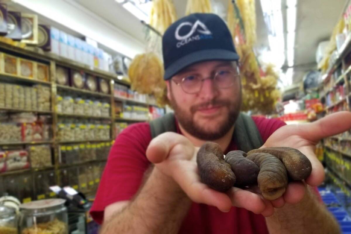 Saanich-based researcher Teale Phelps Bondaroff holds dried sea cucumbers at a market in Singapore. (Photo courtesy of OceansAsia)