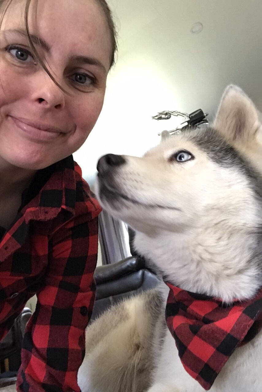 Maria scales is pictured with Shadow, her retired sled dog. (Photo: Maria Scales.)