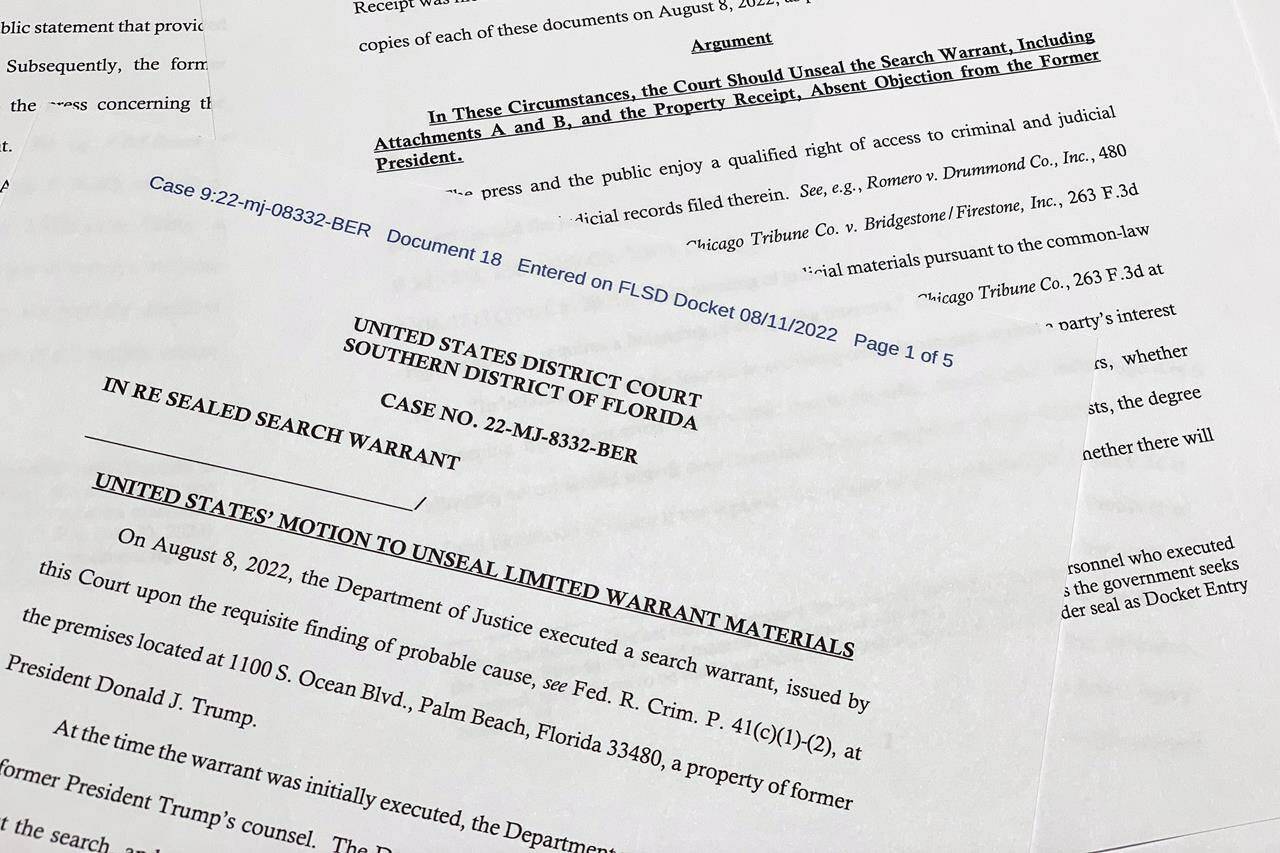 The motion by the Justice Department to the U.S. District Court South District of Florida to unseal the search warrant the FBI received before searching the Florida estate of former President Donald Trump, is photographed Thursday, Aug. 11, 2022. Attorney General Merrick Garland cited the “substantial public interest in this matter” in announcing the request. (AP Photo/Jon Elswick