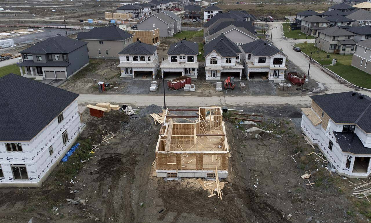 In this photo taken using a drone, homes under construction are seen in a new suburb, Friday, Oct. 15, 2021 in Ottawa. THE CANADIAN PRESS/Adrian Wyld