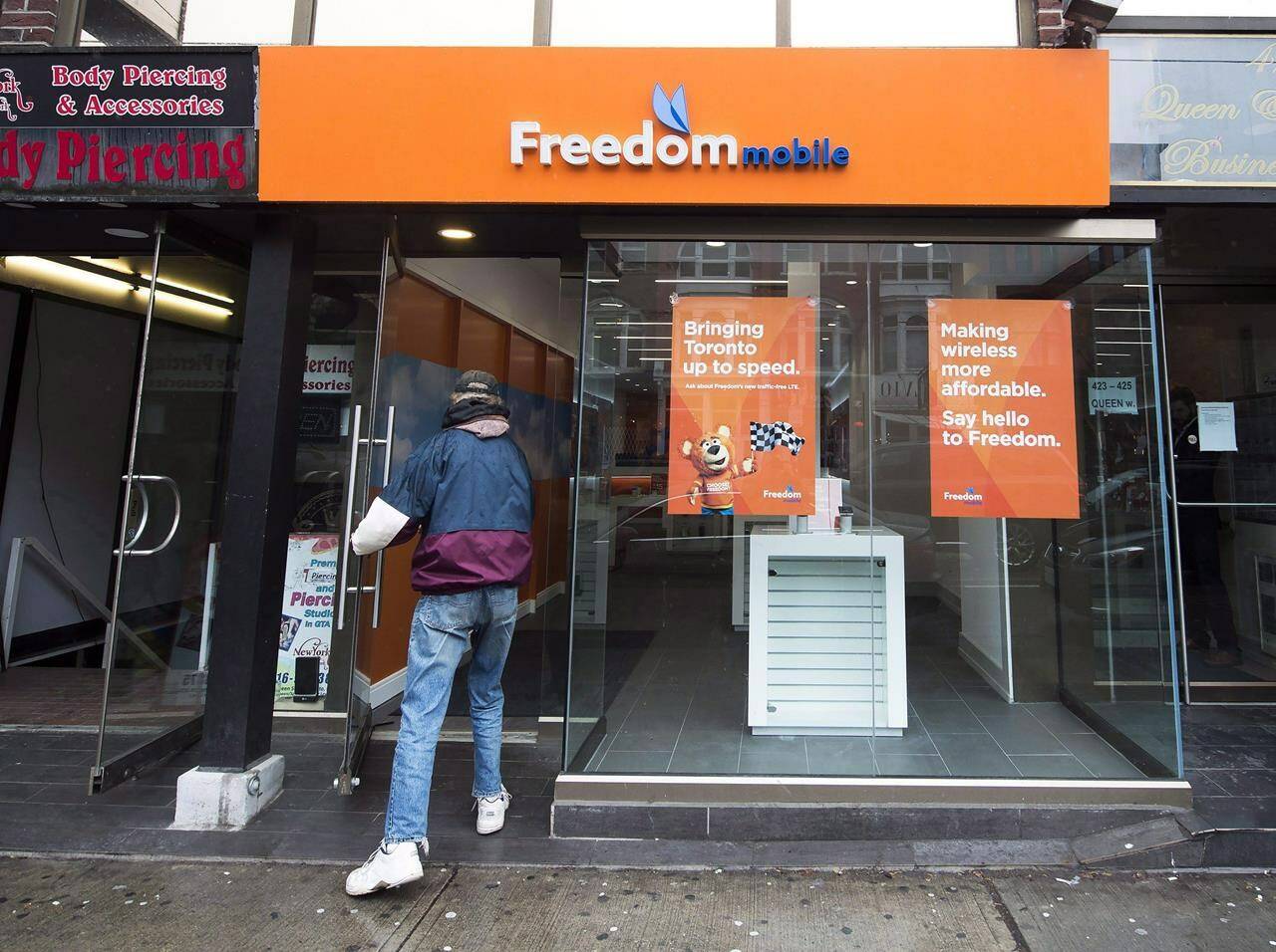 A man enters Freedom Mobile store in Toronto on Thursday, November 24, 2016. THE CANADIAN PRESS/Nathan Denette