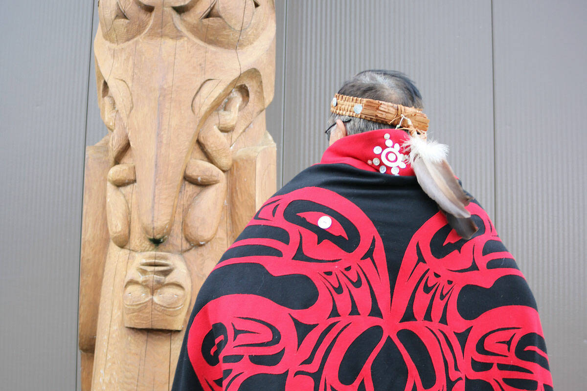 Sim’oogit Ni’isjoohl (Chief Earl Stephens) stands next to a replica of the Ni'isjoohl memorial pole in Laxgalts’ap (Greenville), in the Nass Valley. (Photo courtesy Nisga'a Nation)