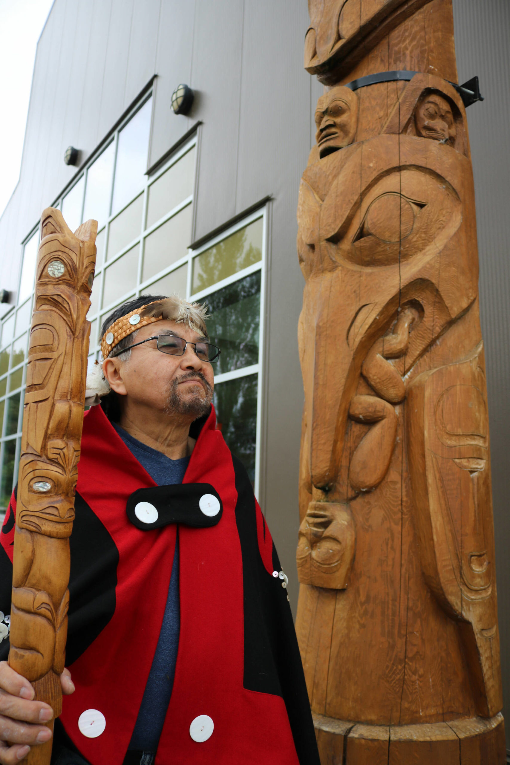 Sim’oogit Ni’isjoohl (Chief Earl Stephens) stands next to a replica of the Ni'isjoohl memorial pole in Laxgalts’ap (Greenville) in the Nass Valley. (Photo courtesy Nisga'a Nation)
