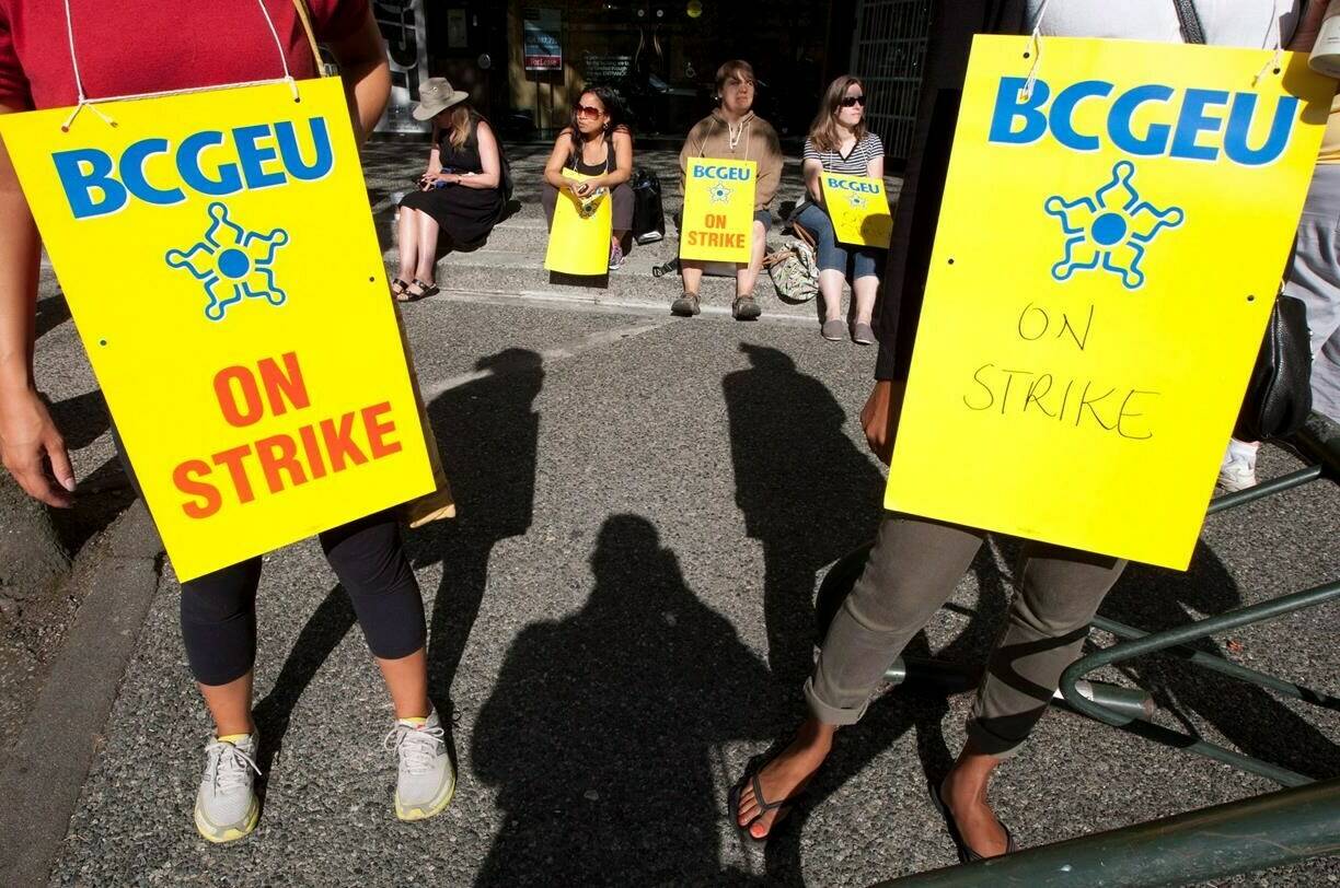 The British Columbia General Employees’ Union says it will set up picket lines at four BC Liquor Distribution Branch wholesale and distribution centres as it begins targeted job action. Strikers are seen in downtown Vancouver during a strike of British Columbia government workers Wednesday, Sept. 5, 2012. THE CANADIAN PRESS/Jonathan Hayward