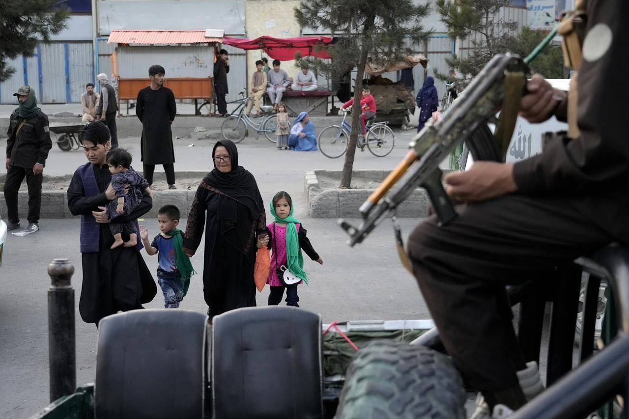 Taliban fighters stand guard in the Shiite neighborhood of Dasht-e-Barchi, in Kabul, Afghanistan, Sunday, Aug. 7, 2022. More than four times as many Ukrainians have been welcomed to Canada as Afghans, official government figures show on the first anniversary of the Taliban seizing control of Kabul. THE CANADIAN PRESS/AP-Ebrahim Noroozi