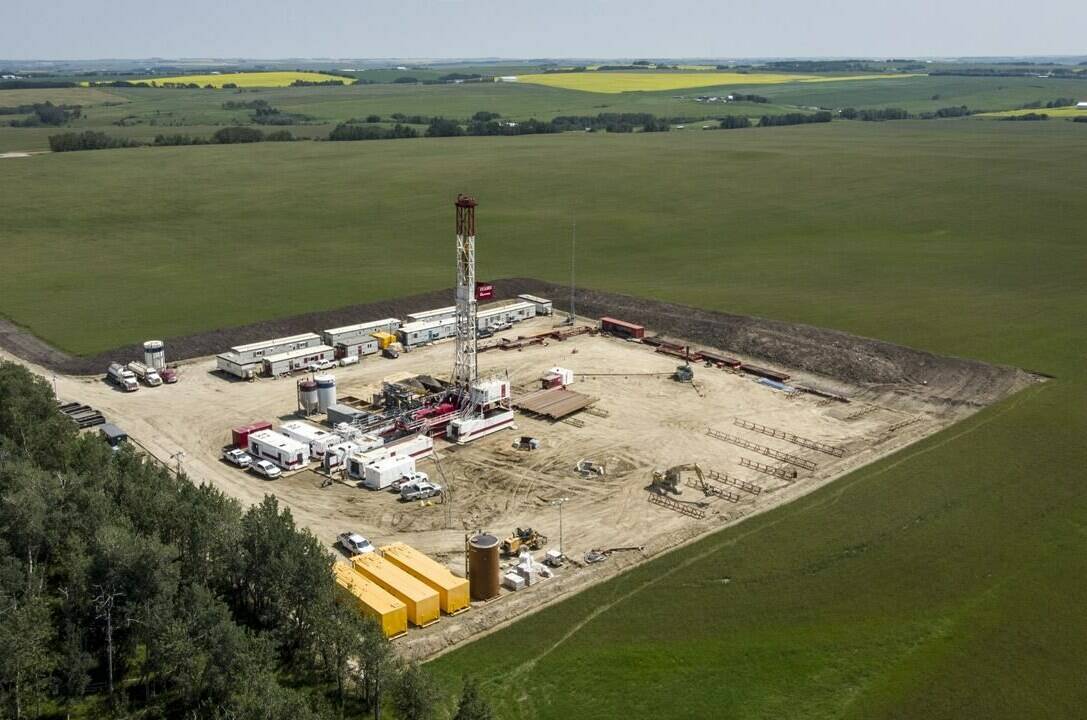 Statistics Canada says manufacturing sales fell 0.8 per cent to $71.8 billion in June as the petroleum and coal product sector helped lead the way lower. An oil drilling rig operates surrounded by canola and hay fields near Cremona, Alta., Monday, July 12, 2021.THE CANADIAN PRESS/Jeff McIntosh