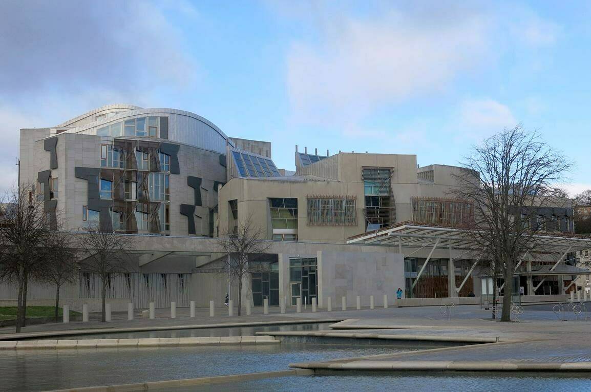 FILE - This file photo taken March 16, 2014 shows a general view of the Scottish Parliament in Edinburgh, Scotland. A law has come into force in Scotland to ensure period products are available free of charge to anyone who needs them. The Scottish government said it became the first in the world to legally protect the right to access free period products when its Period Products Act came into force Monday. (AP Photo/Jill Lawless, File)