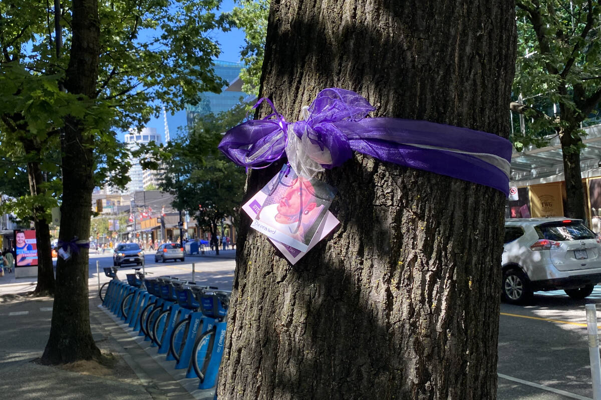 Moms Stop the Harm tied purple ribbons along Robson Street in Vancouver on Tuesday Aug. 16 to memorialize the 10,000 people who have died of toxic drugs in B.C. since a public health emergency was declared in 2016. (Cole Schisler/Black Press Media)