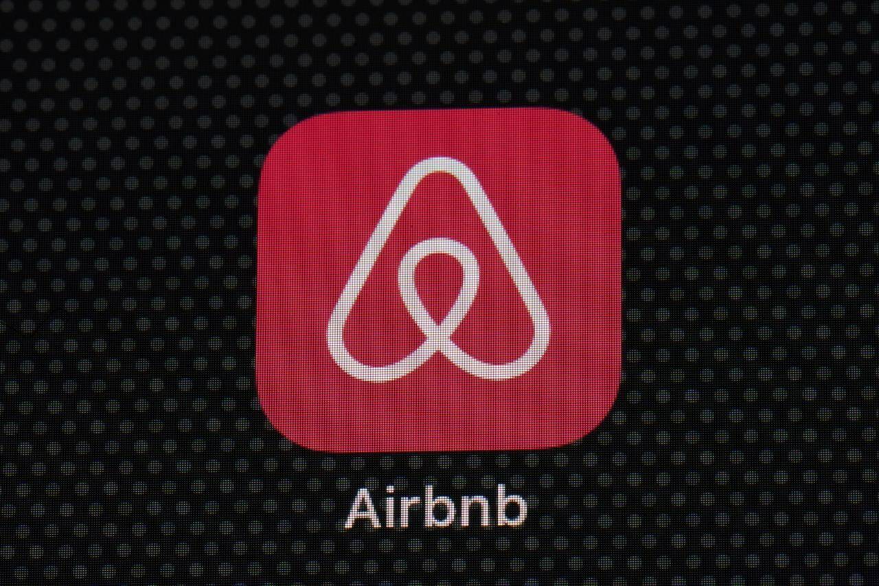 FILE - The Airbnb app icon is displayed on an iPad screen in Washington, D.C., on May 8, 2021. Airbnb announced Tuesday, Aug. 16, 2022, that it will use new methods to spot and block people who try to use the short-term rental service to throw a party. The company said it has introduced technology that examines the would-be renter’s history on Airbnb, how far they live from the home they want to rent, whether they’re renting for a weekday or weekend, and other factors. (AP Photo/Patrick Semansky, File)