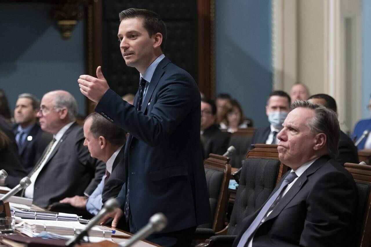 French Language Minister Simon Jolin-Barrette responds to the Opposition while Quebec Premier François Legault, right, reacts during question period on June 1, 2022, at the legislature in Quebec City. Jolin-Barrette says new data from the Canadian census shows the French language is in danger in the province. THE CANADIAN PRESS/Jacques Boissinot