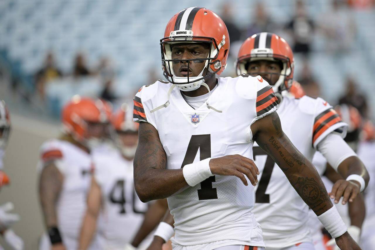 FILE - Cleveland Browns quarterback Deshaun Watson warms up before a preseason NFL football game against the Jacksonville Jaguars, Aug. 12, 2022, in Jacksonville, Fla. A person familiar with the situation tells The Associated Press on Thursday, Aug. 18, 2022, that Watson has reached a settlement with the NFL and will serve an 11-game suspension and pay a $5 million fine rather than risk missing his first season as quarterback of the Browns following accusations of sexual misconduct while he played for the Houston Texans. (AP Photo/Phelan M. Ebenhack, File)