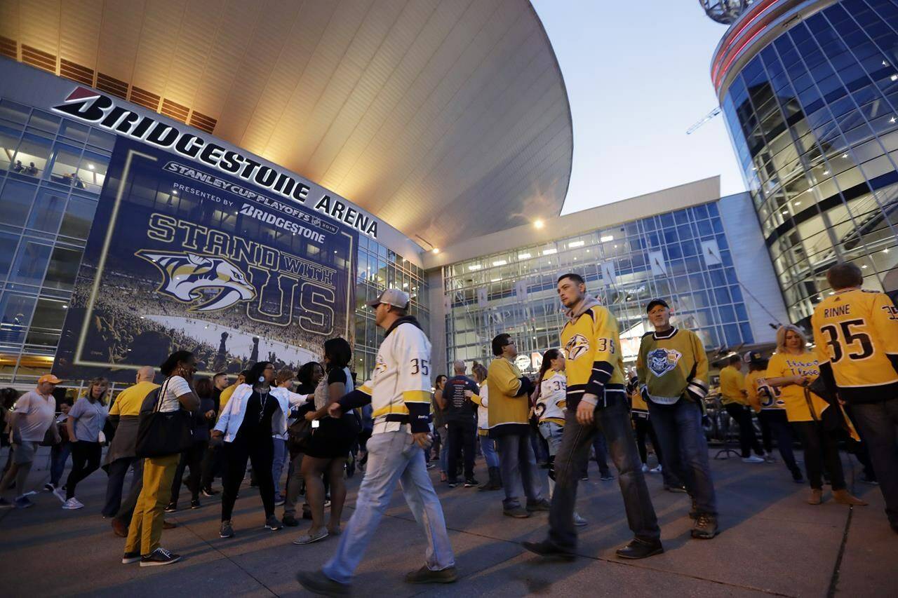 FILE - In this April 10, 2019, file photo, fans arrive at Bridgestone Arena for Game 1 of an NHL hockey first-round playoff series between the Nashville Predators and the Dallas Stars in Nashville, Tenn. The NHL will holding its awards and draft in Music City in June 2023, the first time the league has held both in the same city since 2006, the league announced Thursday, Aug. 18, 2022. (AP Photo/Mark Humphrey, FIle)