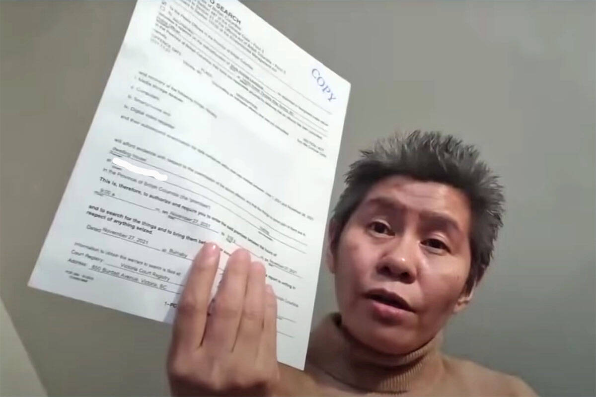 Romana Didulo, the self-proclaimed “Queen of Canada”, holds up a search warrant conducted against her on Nov. 27, 2021. She recently encouraged followers to arrest Peterborough police for COVID-related “crimes against humanity.” (Youtube/LadyDragon)