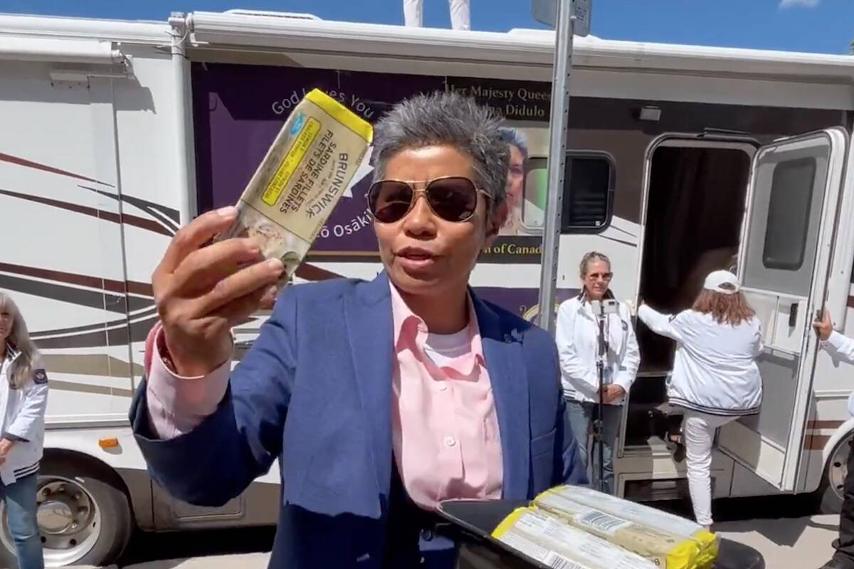 Romana Didulo, the self-proclaimed “Queen of Canada”, hands out sardines to followers at an event in Peterborough, Ont. where participants looked to arrest police for COVID-related “crimes against humanity.” Some protesters have been charged with assaulting police at the event. (CarymaRules/Twitter)