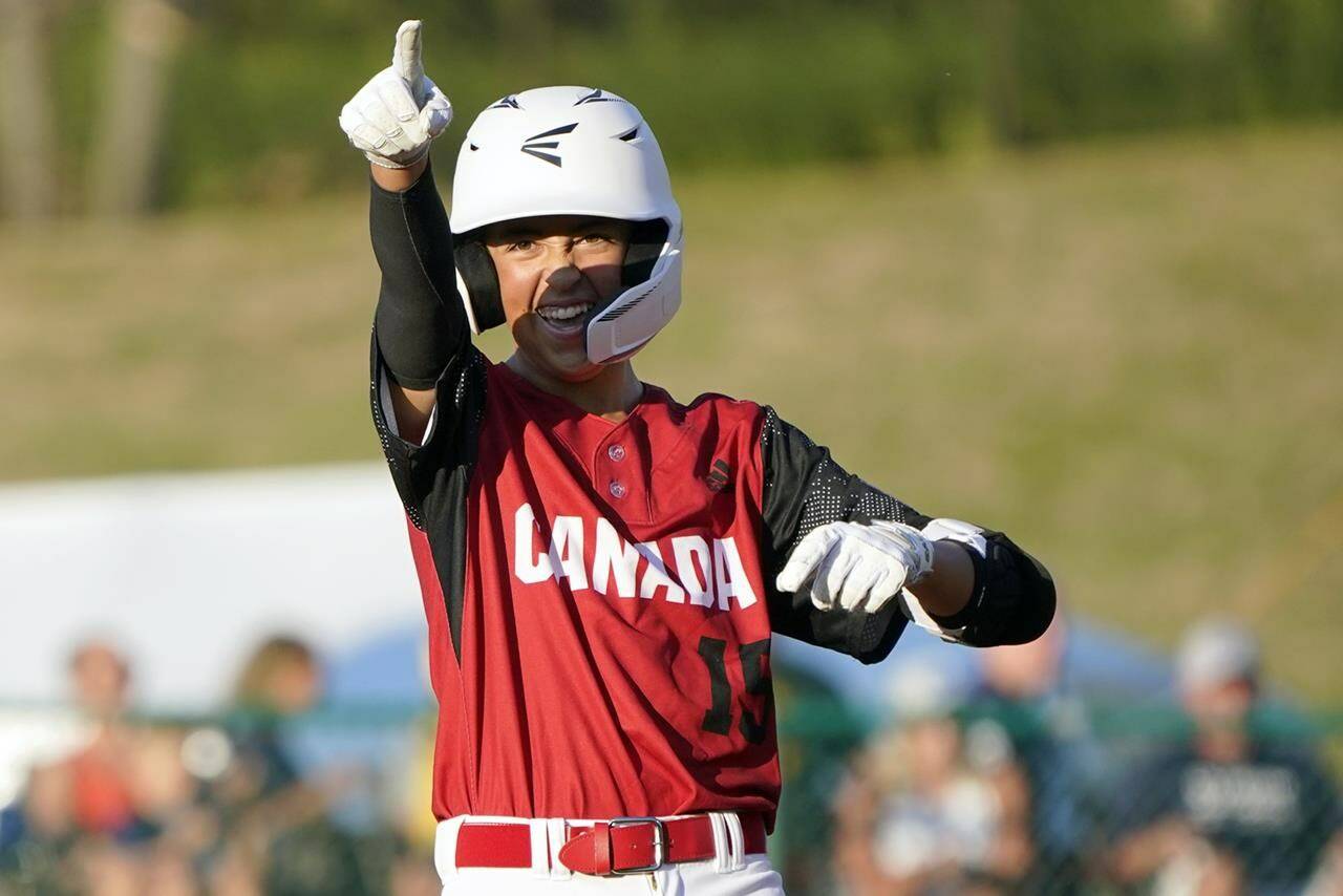 Canada’s Benjamin Dartnell reacts after driving in three runs on his double against Japan during the sixth inning of a baseball game at the Little League World Series tournament in South Williamsport, Pa., Friday, Aug. 19, 2022. (AP Photo/Tom E. Puskar)