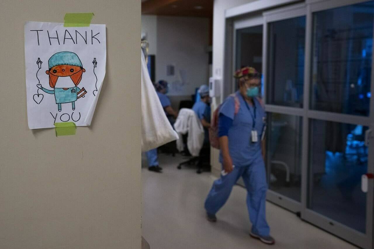 A health-care worker walks past a thank you sign in the intensive care unit at the Humber River Hospital during the COVID-19 pandemic in Toronto on January 25, 2022. A new survey suggests there is a significant decrease in the well-being of physicians across Canada as many doctors say their mental health is worse now than before the COVID-19 pandemic. The Canadian Medical Association’s new National Physician Health Survey indicates 53 per cent of respondents report symptoms of burnout including emotional exhaustion and depersonalization. THE CANADIAN PRESS/Nathan Denette