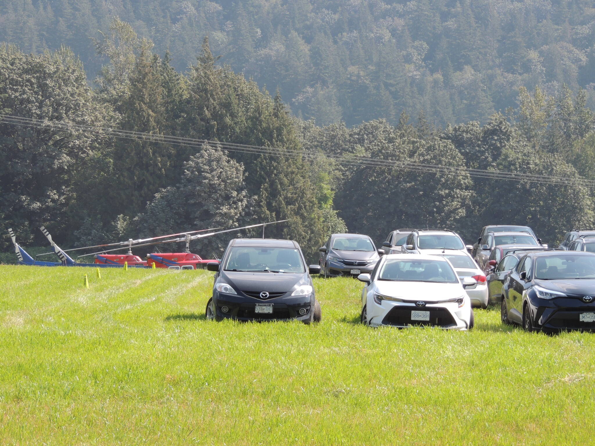 Film crew cars and helicopters were parked across from Harrison Resort Golf Course as part of the filming of “Hourglass” in the Harrison Lake area. (Adam Louis/Observer)