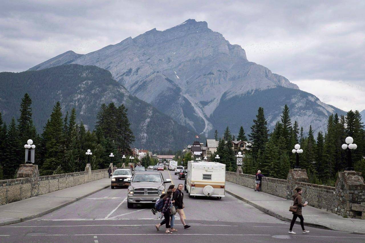 Smoke haze from forest fires burning in Alberta and British Columbia hangs over Banff, Alta., in Banff National Park, on Friday, July 21, 2017. Canada’s busiest national park aims to look for better ways to help visitors get around in the coming years as it works to address climate change and strengthen Indigenous relations.THE CANADIAN PRESS/Jeff McIntosh